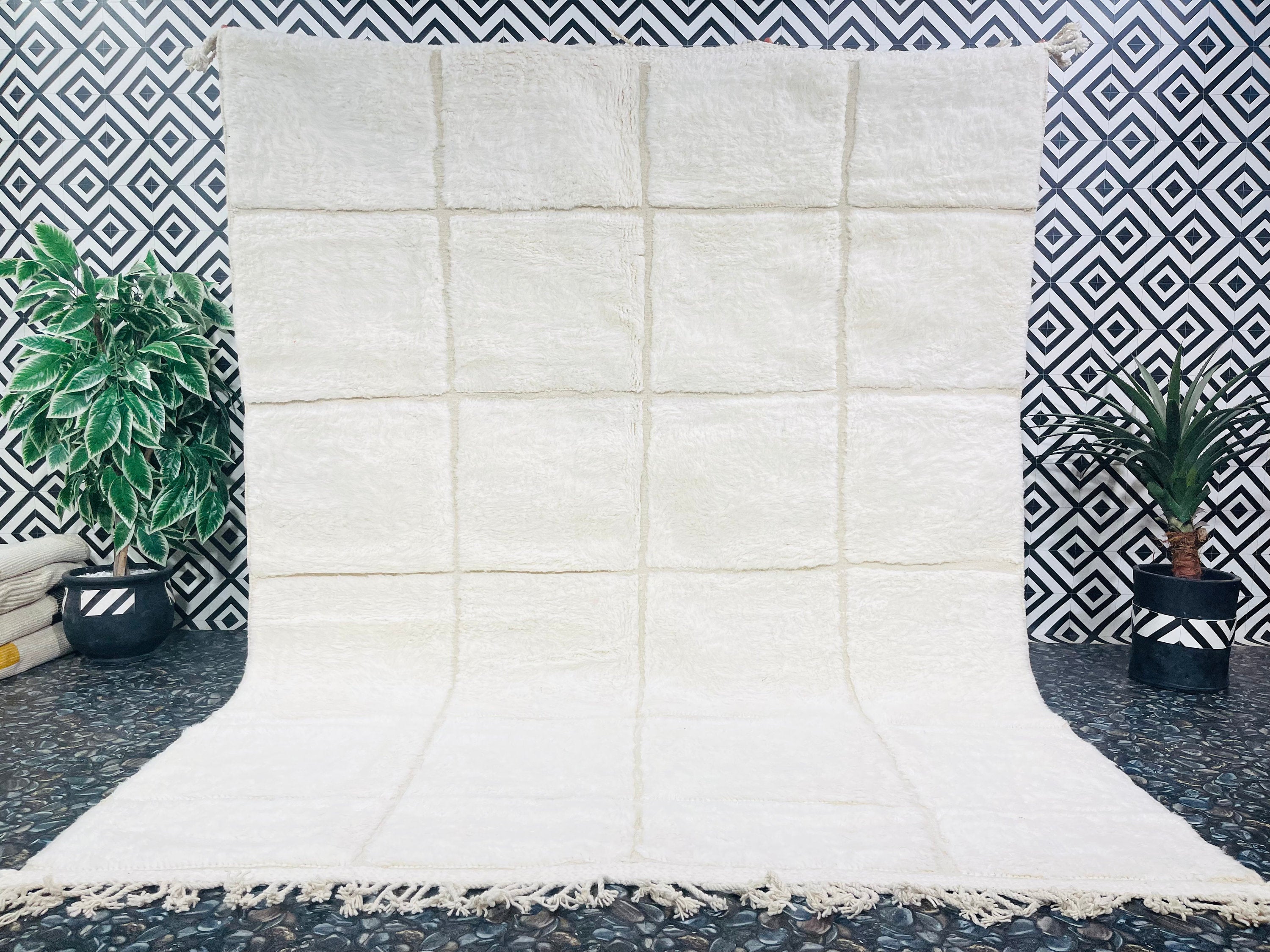 white textured rug against geometric patterned wall