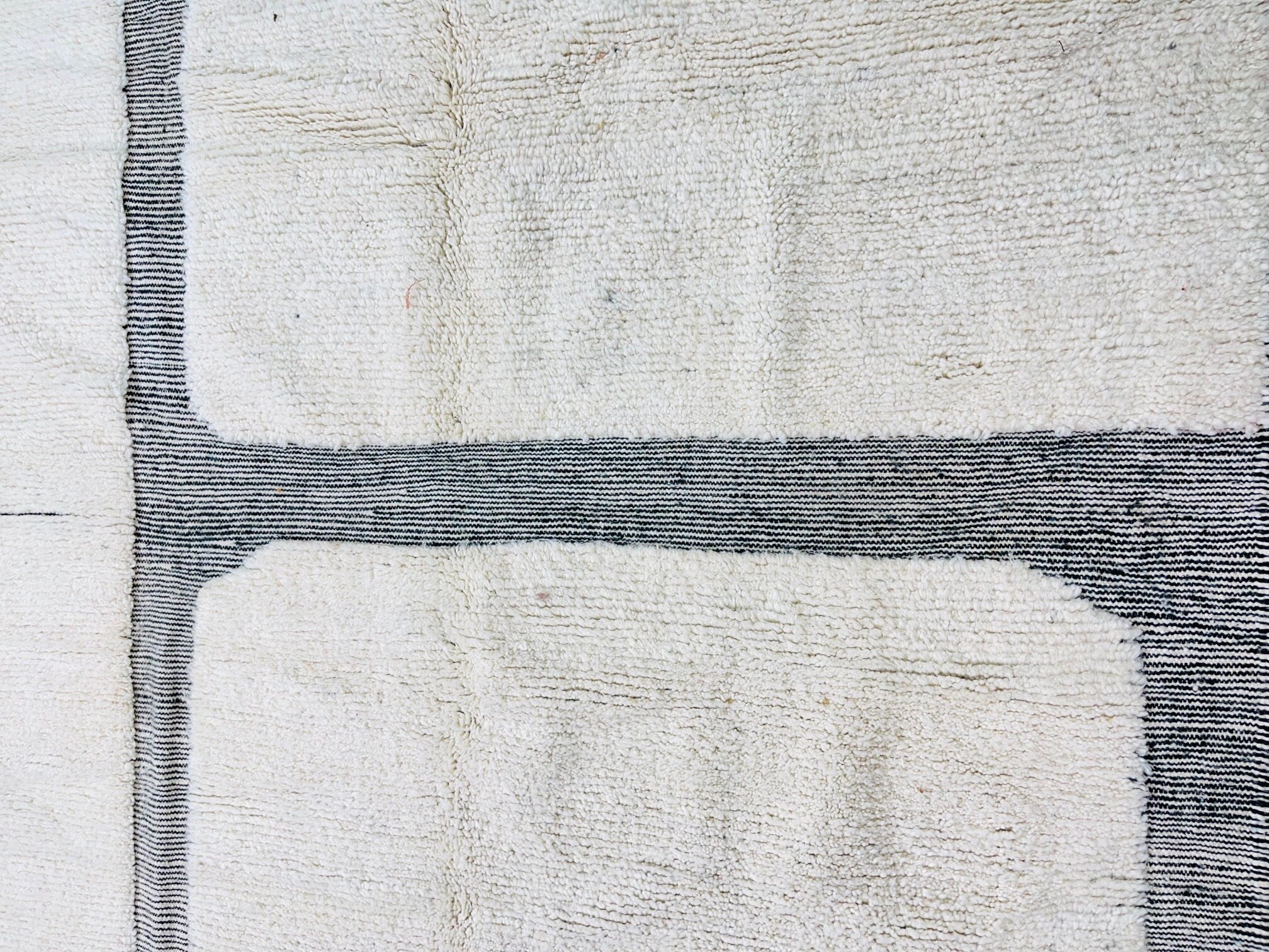 cream textured rug with black lines design