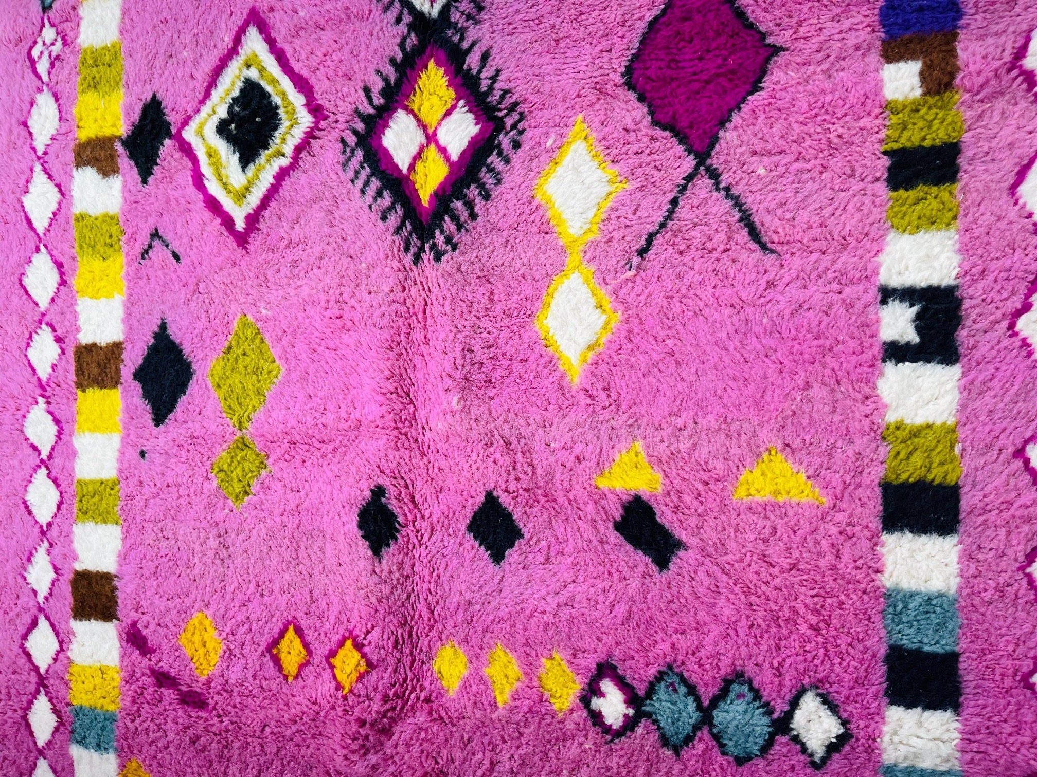 colorful geometric design on a pink rug