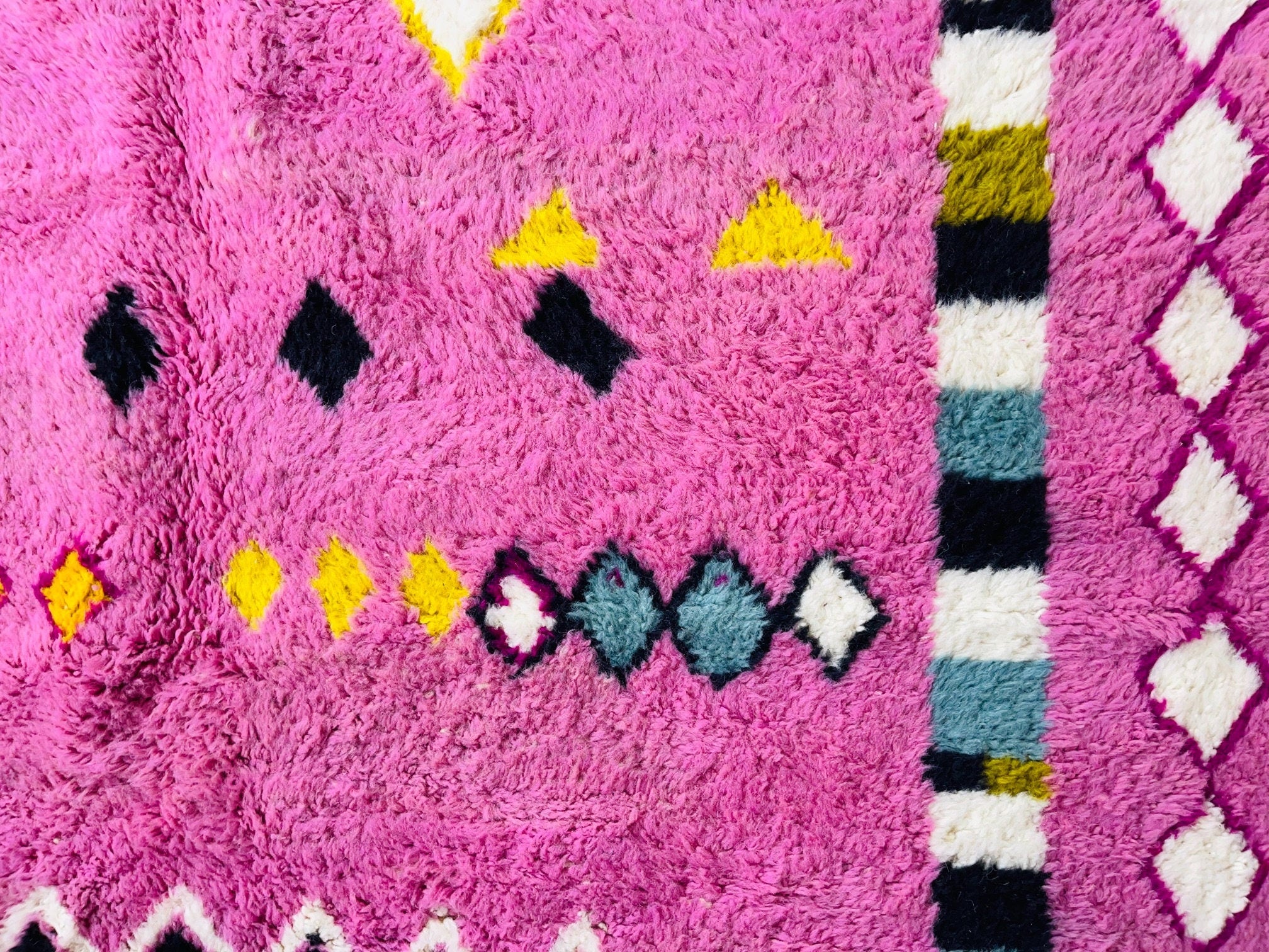 colorful pink patterned rug with geometric designs