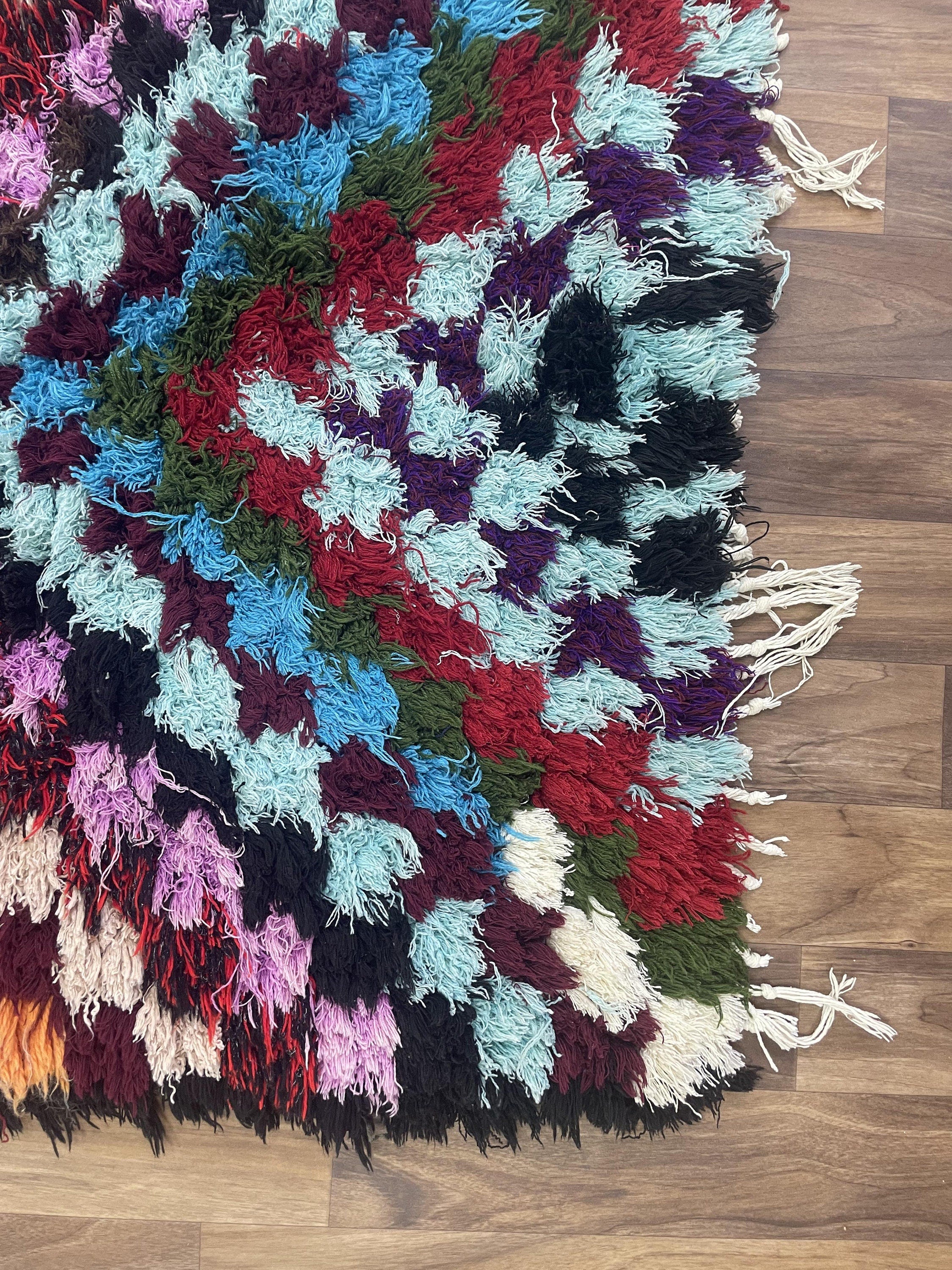 Colorful, fluffy handmade rug with vibrant patterns, ideal for home decor and styling.