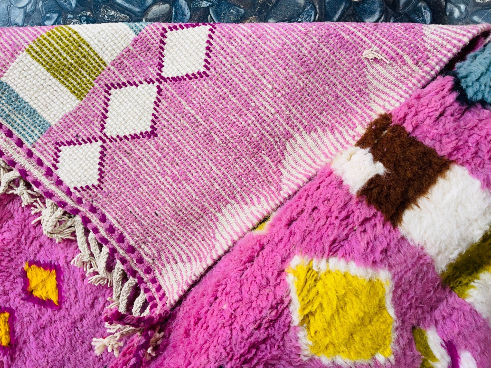 colorful patterned blankets on textured surface