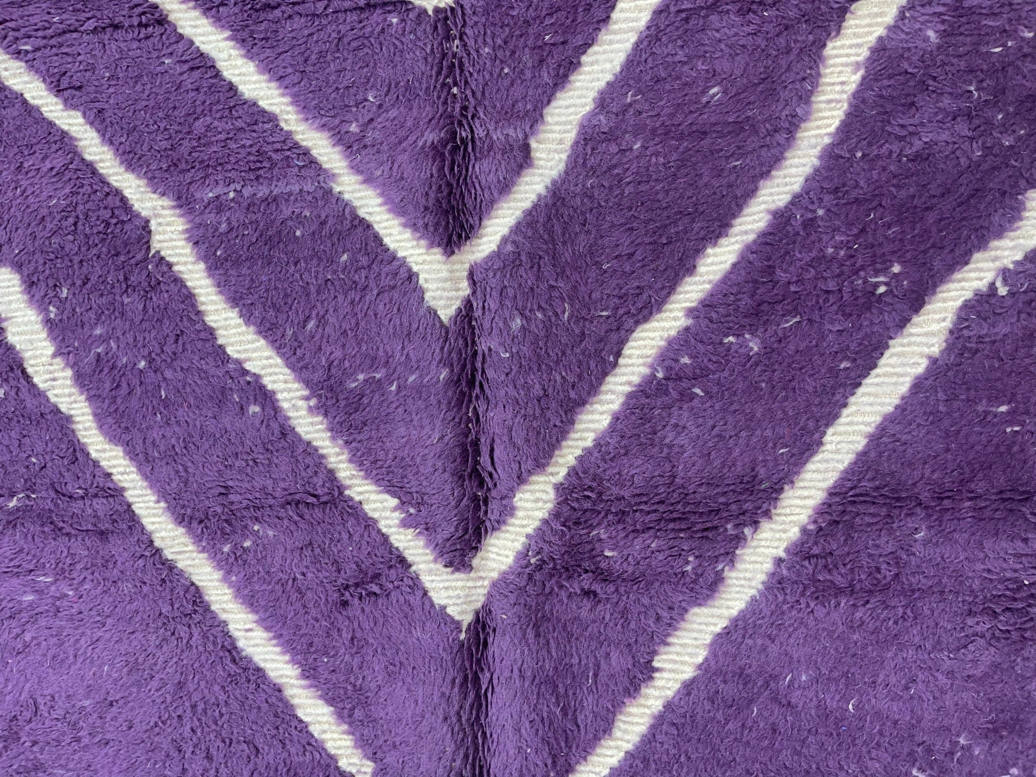 purple and white patterned textile design closeup