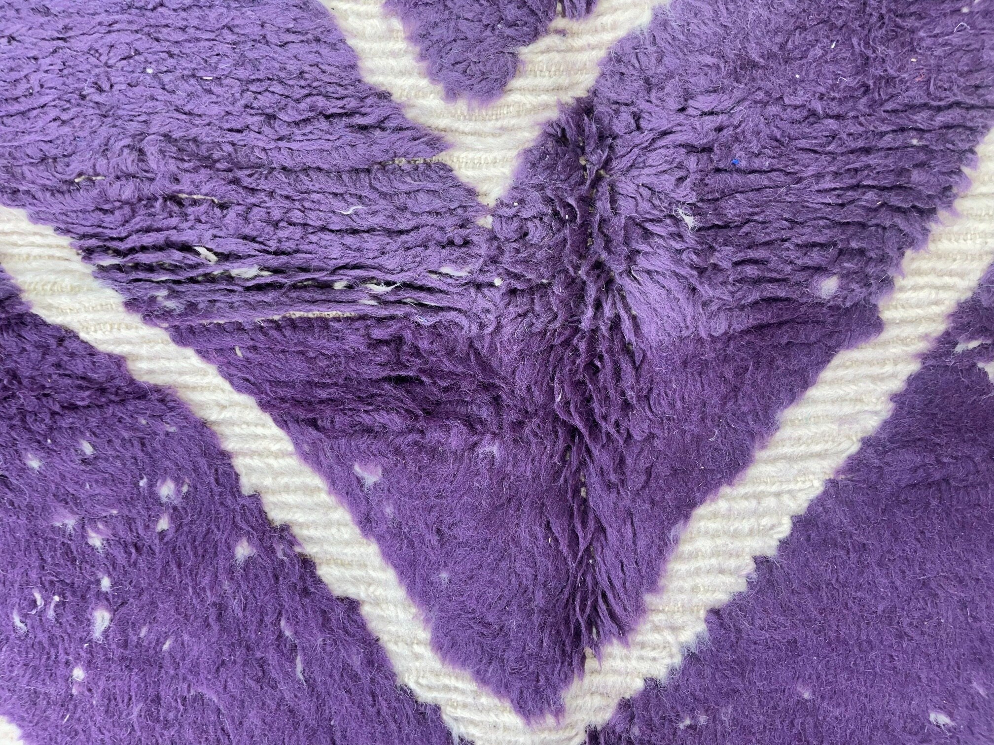 purple and white patterned textile fabric closeup