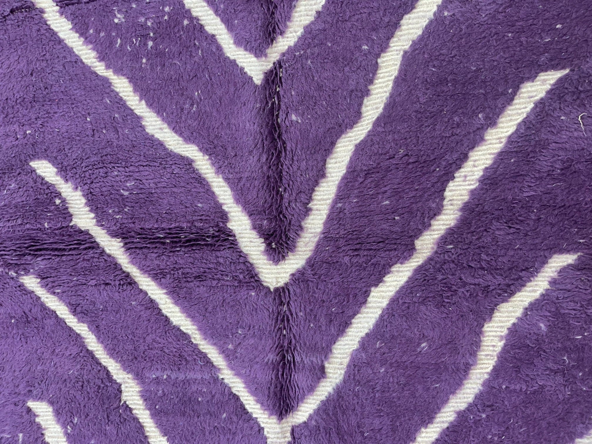 purple textured fabric with white zigzag pattern