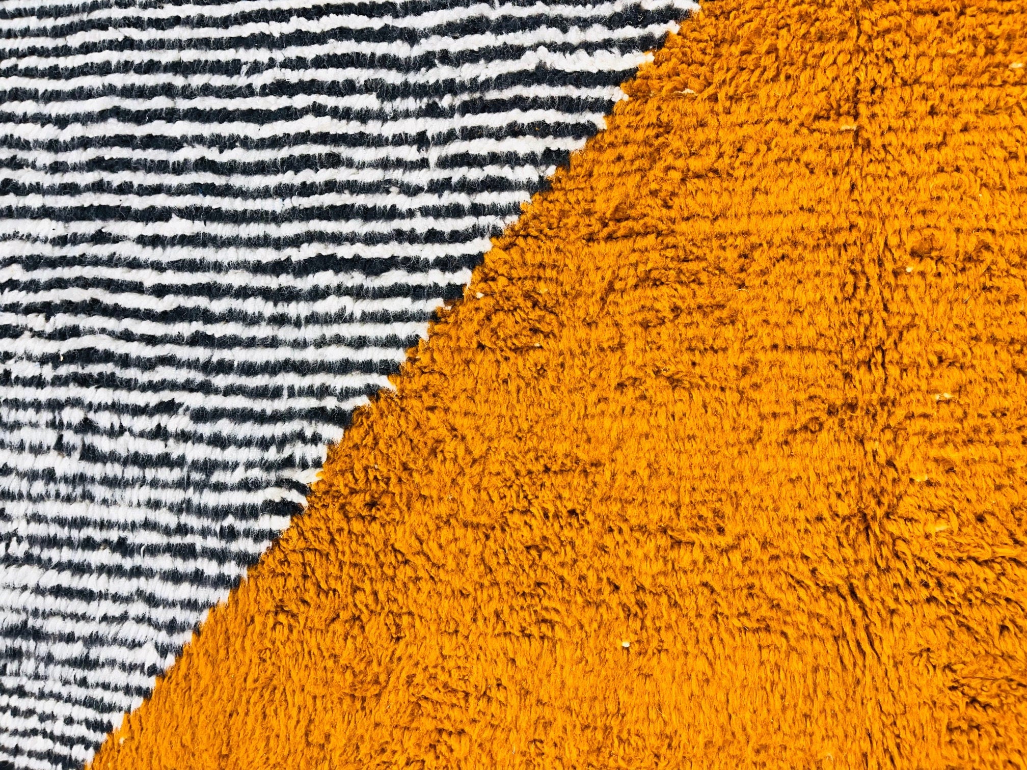 striped black white orange textured fabric closeup