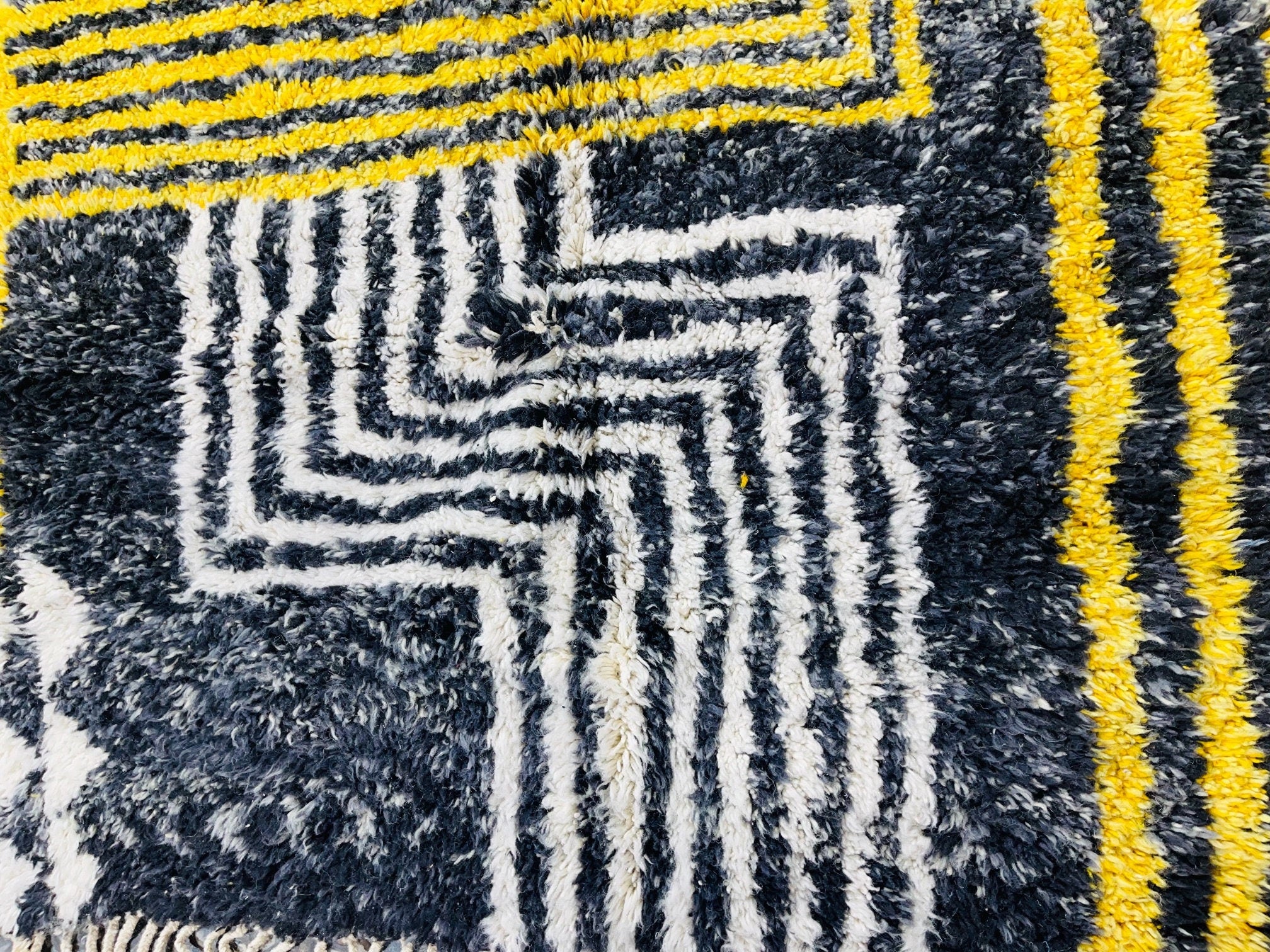 black and white striped rug with yellow accents