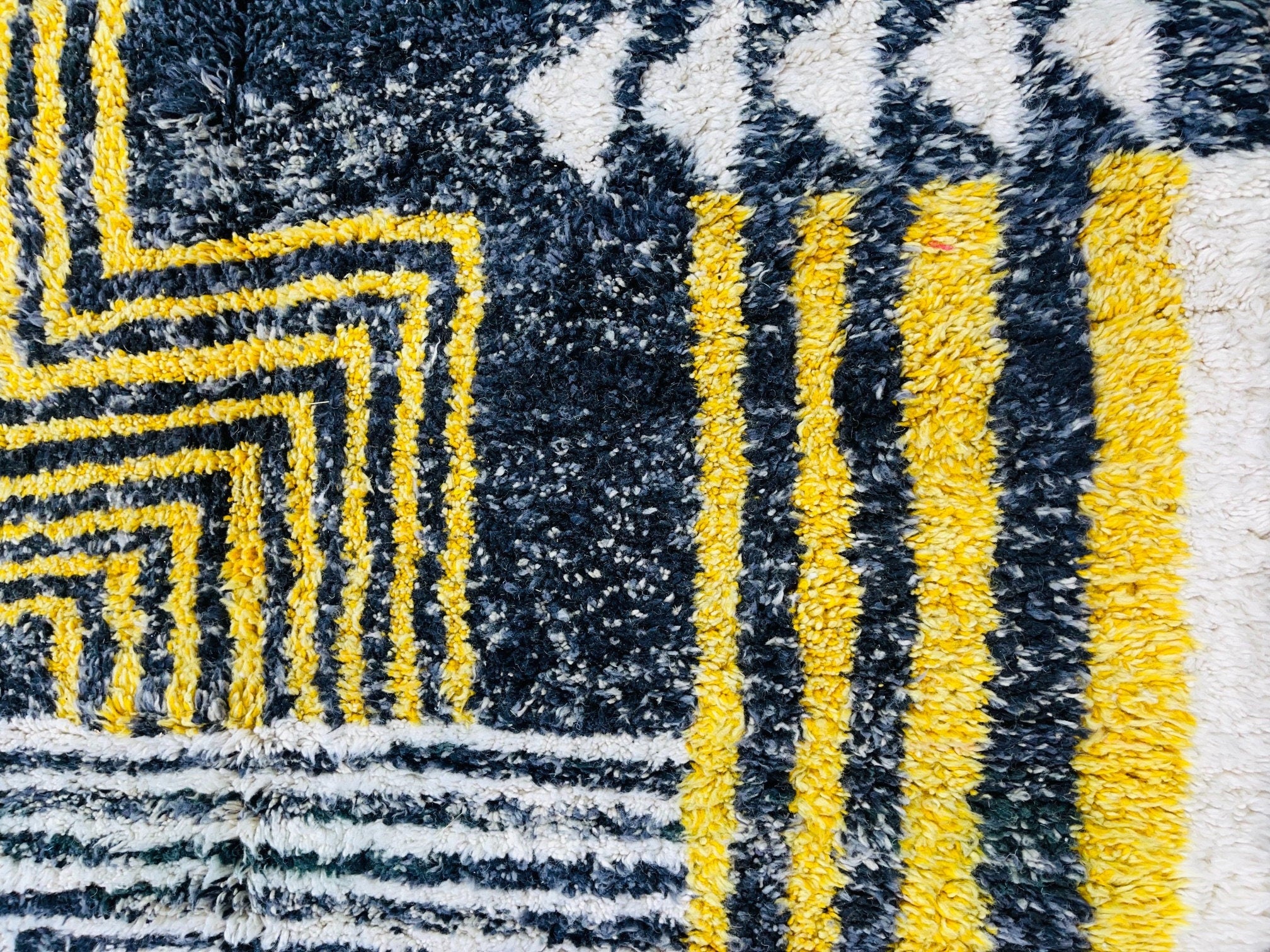 textured rug with yellow and black patterns