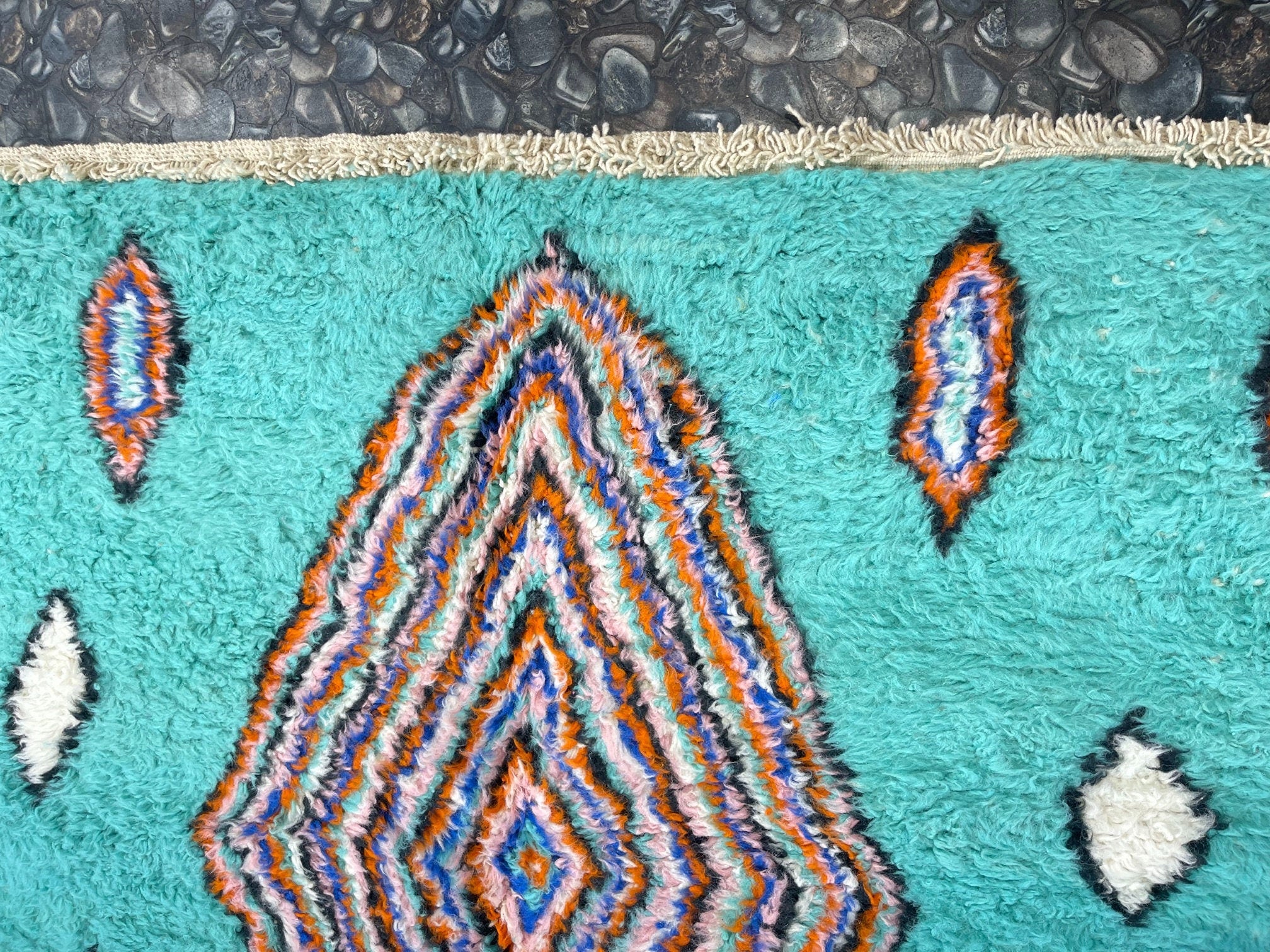 vibrant patterned rug with turquoise and orange