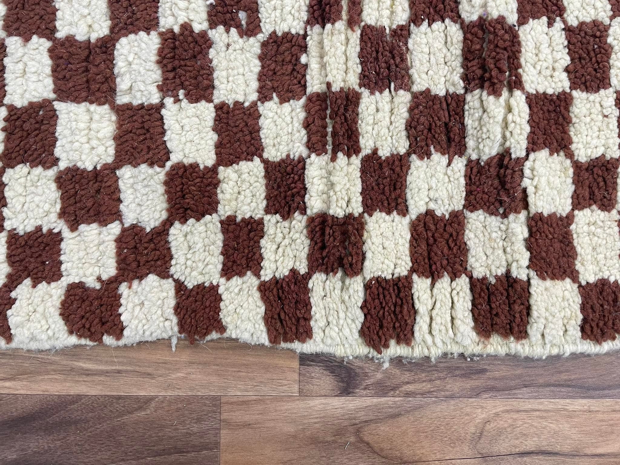 Checkered plush rug in earthy tones, perfect for cozy home decor and stylish interiors.