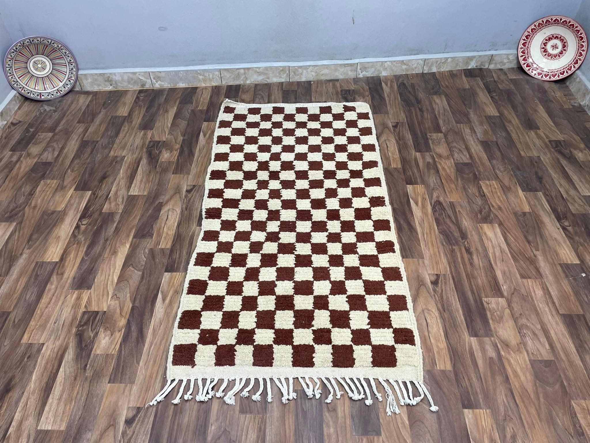 Handwoven checkered rug in brown and cream, perfect for home decor and comfort.