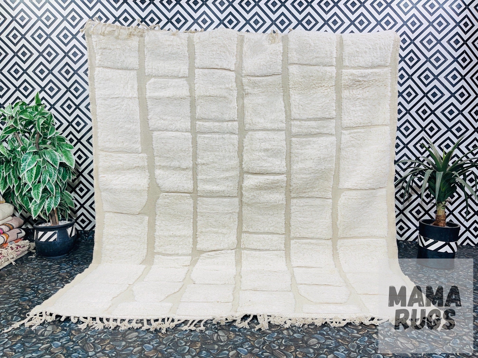handmade cream rug on patterned black backdrop