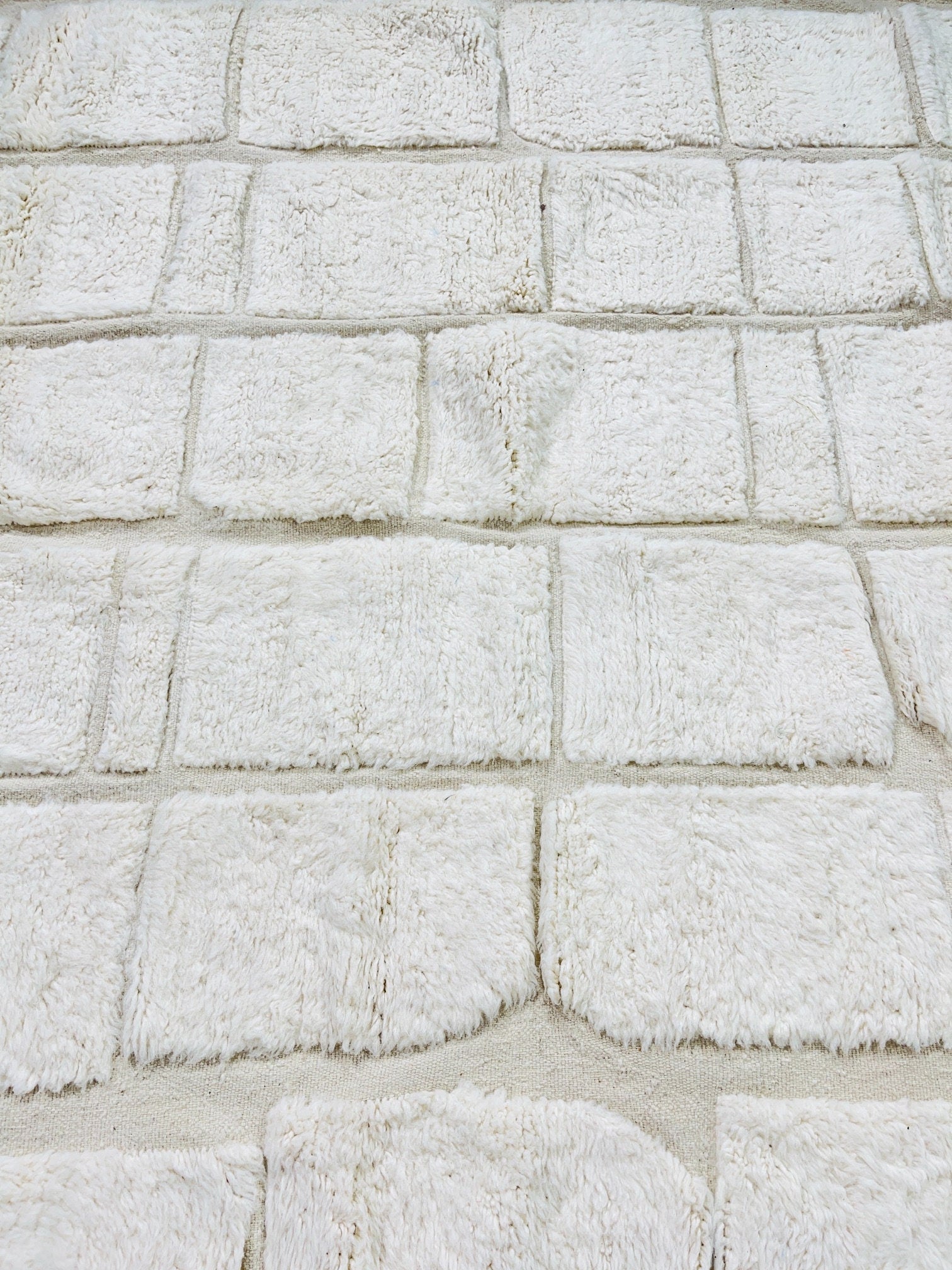 white textured carpet with plush square tiles