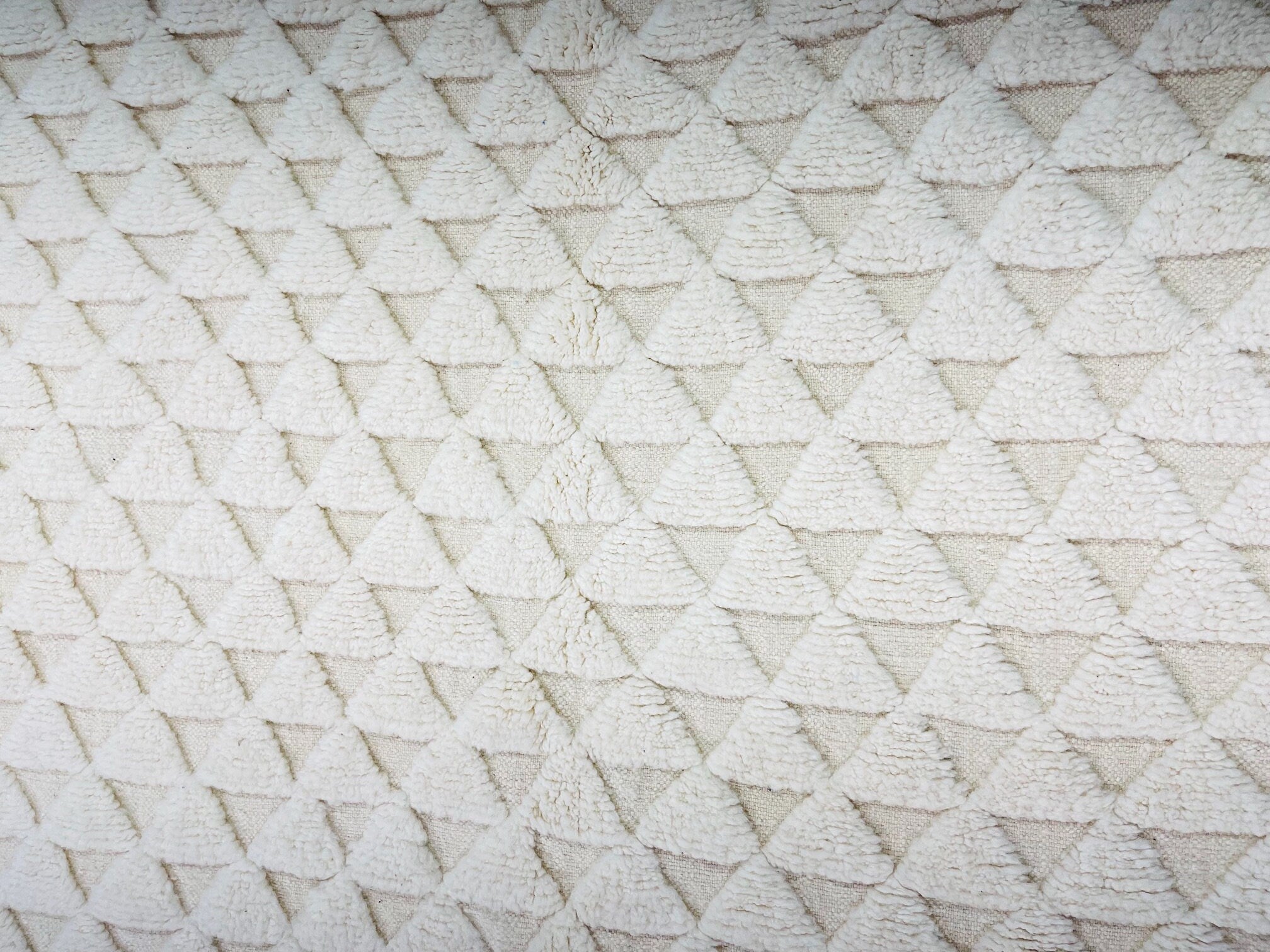 textured cream fabric with triangle pattern design