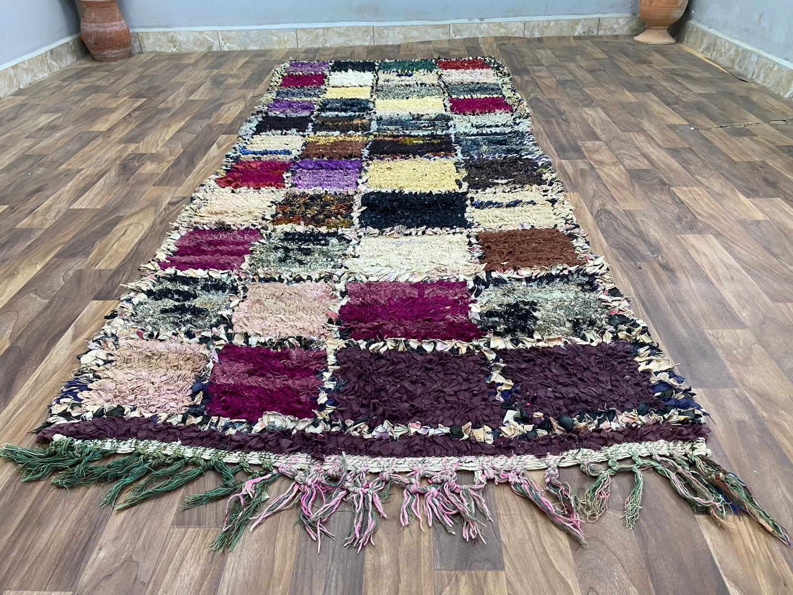 Colorful patchwork rug with fringes, perfect for enhancing any living space decor.