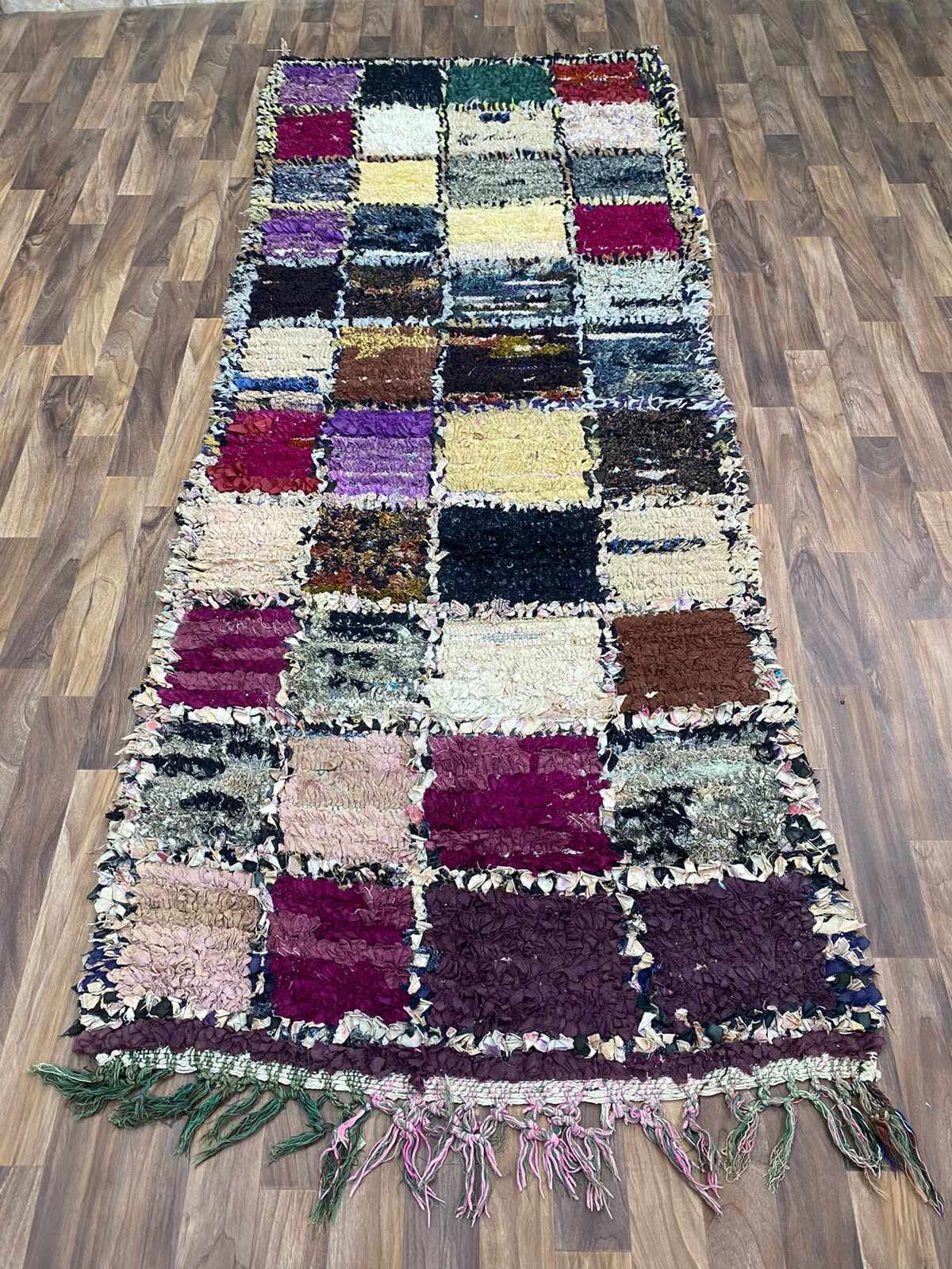 Colorful patchwork area rug with fringed edges, perfect for home decor and comfort.